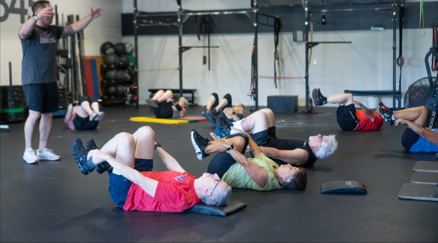 CrossFit 845 Get Moving members following a coach through floor exercises